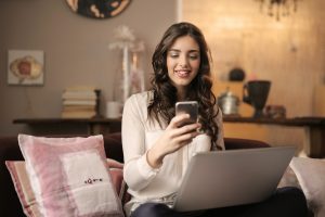 Woman on her mobile phone rating her package returns experience.