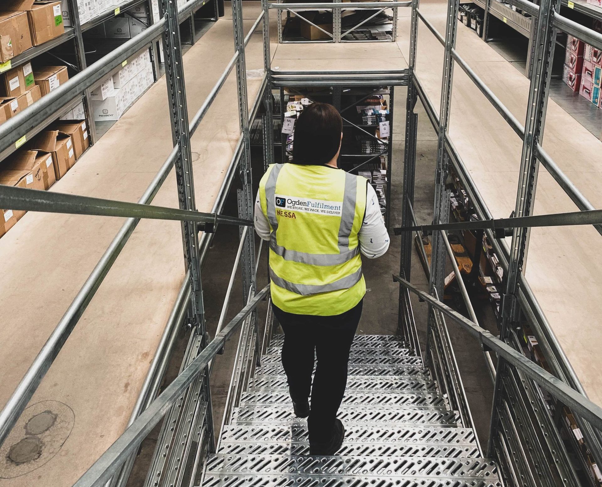 Ogden staff member walking down the warehouse steps