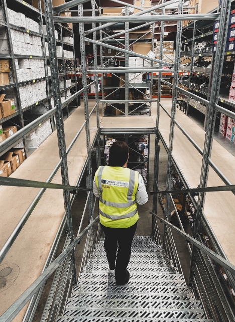 Staff member walking down the mezzanine