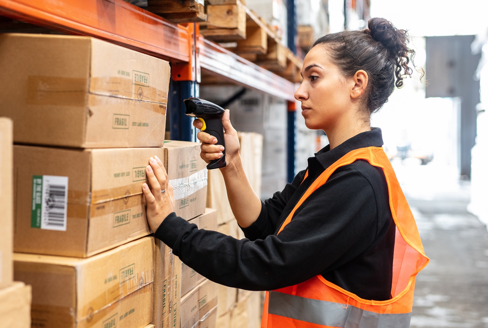 fulfilment centre employee selecting and scanning packages