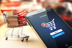 Mobile phone or smartphone with cart and boxes and bag.