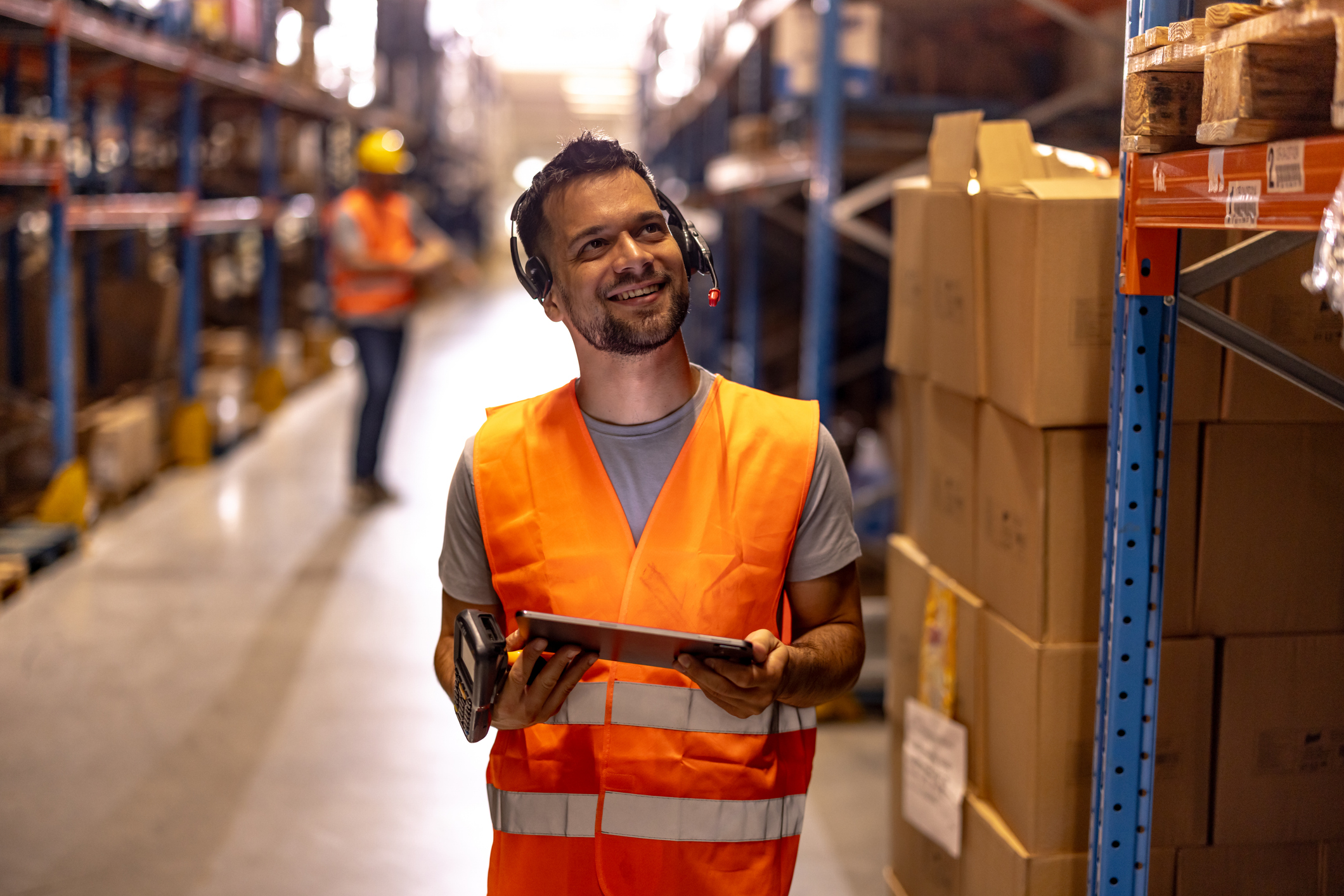 Portrait of male warehouse worker in large warehouse distribution centre