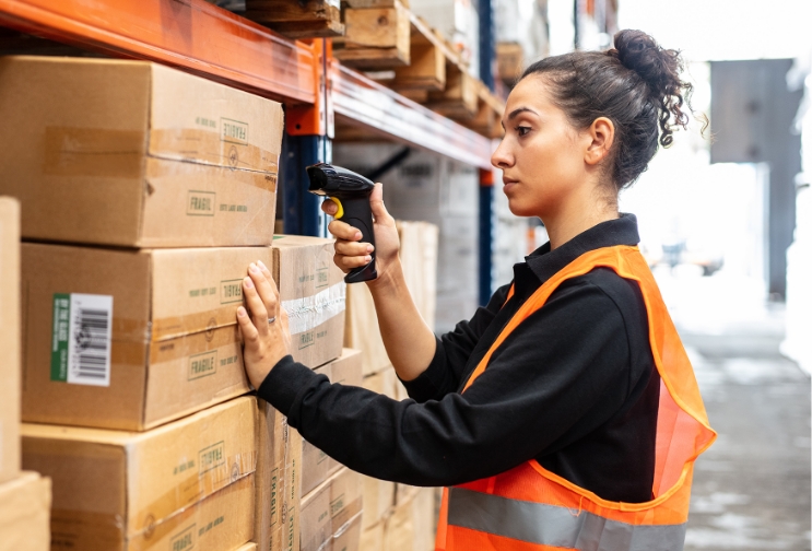 Fulfilment centre worker scanning boxes