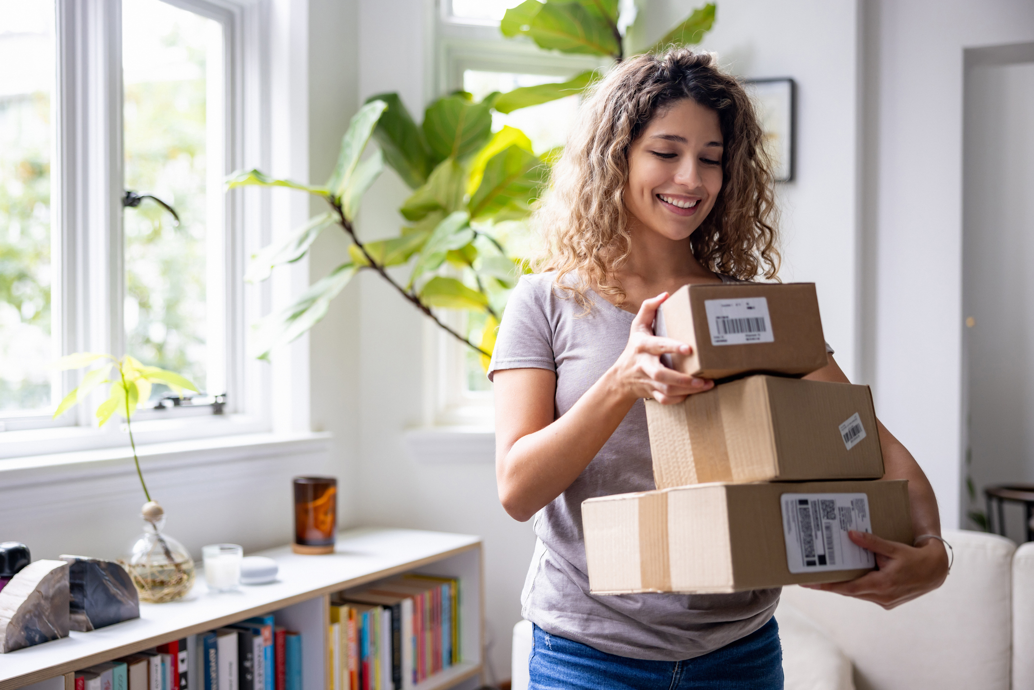 woman at home receiving packages in the mail after shopping online