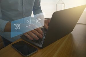 A man is in front of a laptop purchasing goods online. Online digital ecommerce concept
