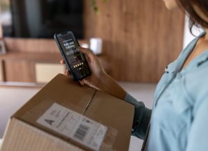 Woman at home shopping online and rating her experience on the app after receiving a package
