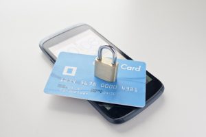 Mobile security with smartphone, credit card and lock.